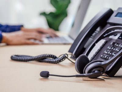 Communication support, call center and customer service help desk. telephone devices with VOIP headset in office.Customer service support (call center) concept.
